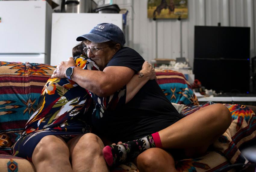 Amy Harper and Romana Harding embrace during an interview on Tuesday, July 29, 2025, outside of Midway, TX.
